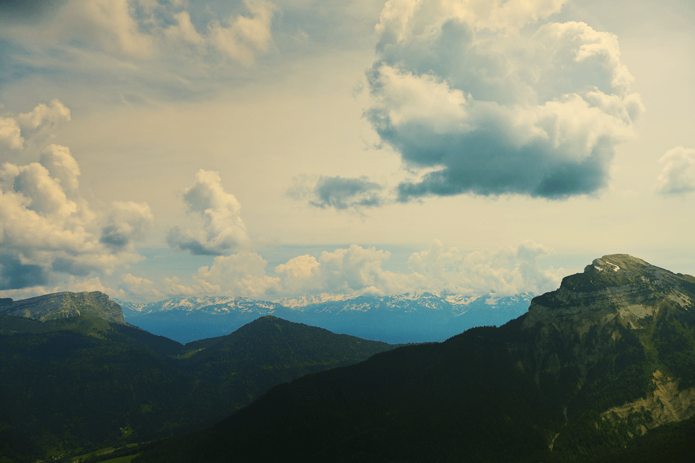 Mountain ridgeline with clouds rolling over the peaks
