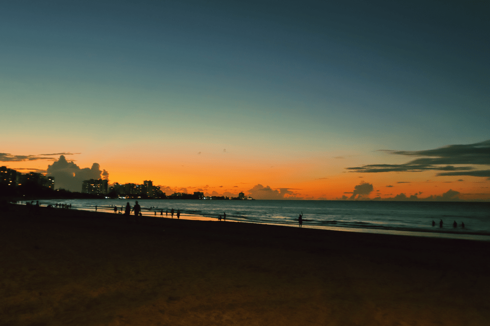 Sunset over the beach with the San Juan skyline silhouetted